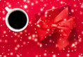 Winter holiday gift box, coffee cup and glowing snow on red flatlay background, Christmas time present surprise Royalty Free Stock Photo