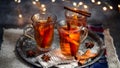 Hot drink for New Year, Christmas or autumn holidays. Mulled cider or spiced punch, tea or mulled white wine with lemon, apples, Royalty Free Stock Photo