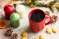 hot drink in red cup next to cookies and candles on the table. winter holidays, Christmas, New Year Royalty Free Stock Photo
