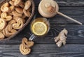 hot drink tea with lemon, honey and ginger with gingerbread cookies on wooden background