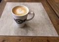 Hot drinks. A cup of caffe latte or cappuccino on a table in a Espresso House cafe. Royalty Free Stock Photo