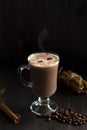 Cup of coffee. glass of hot chocolate with whipped cream, coffee beans and cinnamon sticks on a dark background. Royalty Free Stock Photo
