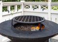 Hot empty barbecue BBQ grill with flaming fire and ember charcoal on black background. Outdoor summer family party Royalty Free Stock Photo