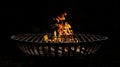 Hot empty portable barbecue BBQ grill with flaming fire and ember charcoal on black background Royalty Free Stock Photo