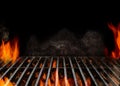 Hot empty portable barbecue BBQ grill with flaming fire and ember charcoal on black background. Waiting for the Royalty Free Stock Photo