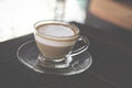 hot espresso macchiato coffee with milk topping in glass cup on Royalty Free Stock Photo