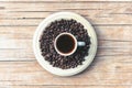 Hot Espresso in white cup and roasted coffee beans on a wooden table, top view Royalty Free Stock Photo