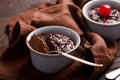 Hot festive French dessert. Chocolate pudding in Ceramic Bakeware with cheery. top view