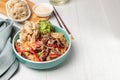 Hot festive Korean dish, noodles with meat and vegetables, close-up. Asian cuisine. Horizontal, copy space