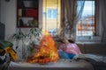 Hot flaming iron on ironing board. In defocused background woman is sleeping on sofa. Concept of fire hazard from Royalty Free Stock Photo