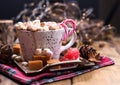 Hot flavored cocoa with marshmallows and caramel. Delicious Christmas drink in cold winter. Free space for text