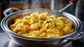 Hot and fluffy scrambled eggs in a pan with steaming aroma. Royalty Free Stock Photo