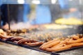 Hot food on Krakow Christmas market. As traditions sausages, kupaty, hot dog, wurst, wiener are cooking on open fire. Traditional