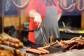 Hot food on Krakow Christmas market. As traditions sausages, kupaty, hot dog, wurst, wiener are cooking on open fire. Traditional