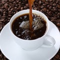 Hot fresh coffee pouring in cup Royalty Free Stock Photo