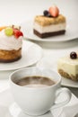 Hot fresh cup of coffee with a variety of cakes Royalty Free Stock Photo