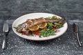 Hot fresh delicious roasted whole trout barbecue with fresh herbs and lemon, on a wooden background close-up Royalty Free Stock Photo