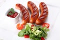 Hot and fried sausages with vegetables and spices Royalty Free Stock Photo