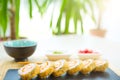 Hot fried Sushi Roll with cream cheese on black stone on bamboo mat decorated. Japanese cuisine Royalty Free Stock Photo