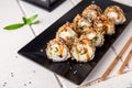 Hot fried Sushi Roll with shrimp, cucumber and unagi sauce. Sushi menu. Royalty Free Stock Photo