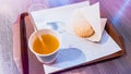 Hot fruit tea and butter cookie on plastic tray at cafe. Eating out. Tasty snack at bakery. Morning breakfast out. Sweet Royalty Free Stock Photo