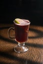 Hot fruit tea with raspberries and apple in a clear glass Royalty Free Stock Photo