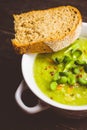 Hot green peas soup on the rustic background Royalty Free Stock Photo