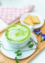 Hot green tea milk with cracker and spoon Royalty Free Stock Photo