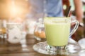 Hot green tea milk in glass mug. Royalty Free Stock Photo