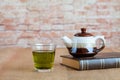 hot green tea with small teapot on wood Royalty Free Stock Photo