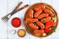 hot grilled juicy beef sausages with fresh thyme on round cutting board Royalty Free Stock Photo