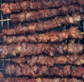 hot grilled lamb meat on skewers barbecued on fireplace