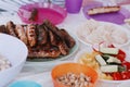 Hot grilled meat sausages with fresh cutted vegetables on the table Royalty Free Stock Photo