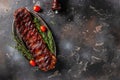 hot grilled spare ribs on cutting board on a dark background. American Spare Ribs in BBQ Sauce. Restaurant menu, dieting, cookbook Royalty Free Stock Photo