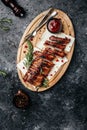 Hot grilled spare ribs on cutting board, Food recipe background. vertical image. top view. place for text Royalty Free Stock Photo