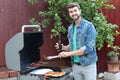 Hot guy preparing dinner in barbecue Royalty Free Stock Photo