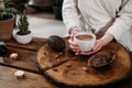 Person giving ceremonial cacao in cup. chocolate drink top view Royalty Free Stock Photo