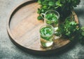 Hot herbal mint tea in glass mugs with leaves