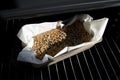 Hot homemade bread with sesame and sunflower seeds on a metal rack in the oven in the sunshine, fresh baked. Gluten free Royalty Free Stock Photo