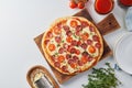 Hot homemade Italian pepperoni pizza with salami, mozzarella on white table Royalty Free Stock Photo