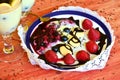 Hot homemade vanilla pudding with strawberries and vine berries