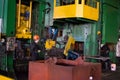 Hot iron in smeltery held by a worker.