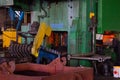 Hot iron in smeltery held by a worker. High precision hot forging product, automotive part production by hot forging process, auto Royalty Free Stock Photo