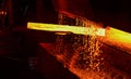 Hot iron in smeltery held by a worker. Melting of metal in a steel plant