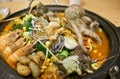 Hot Korean seafood stew with various ingredients including small octopus, shrimps, abalones, trumpet shells, warty sea squirts, a Royalty Free Stock Photo