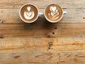 Hot latte and another of cappuccino coffee with two different latte art Royalty Free Stock Photo