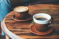 Hot latte coffee and black coffee on vintage wooden table in cafe Royalty Free Stock Photo