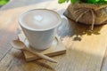 Hot latte coffee in glass cup mug on wood table