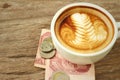 Hot latte coffee with money of Thai Bath