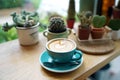 Hot Latte - A cup of coffee with milk and beautiful leaf pattern latte art on wooden table and blurred background. Royalty Free Stock Photo